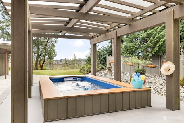 view of swimming pool featuring a pergola, a yard, a patio, and a hot tub