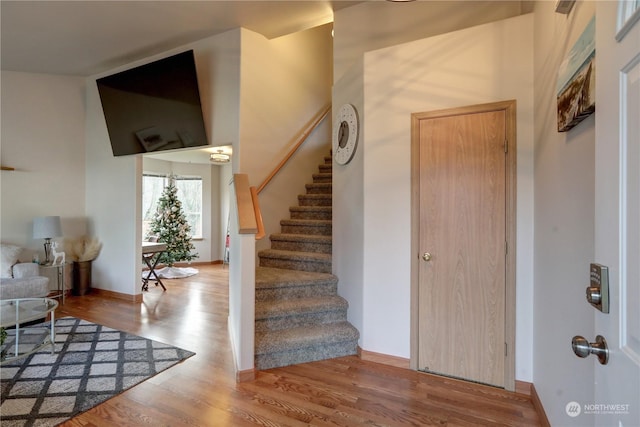 stairs featuring hardwood / wood-style floors