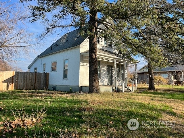 view of side of home featuring a yard