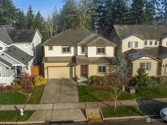 view of property with a garage and a front lawn