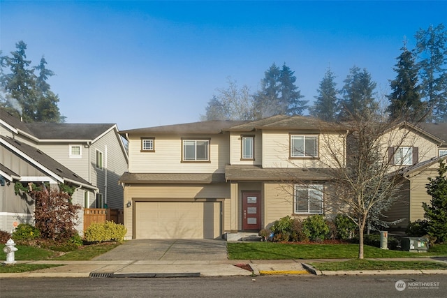 view of front of home with a front yard and a garage