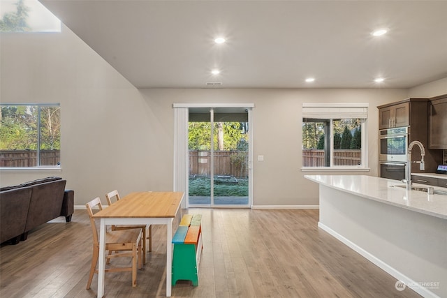 dining room featuring plenty of natural light and light wood-type flooring