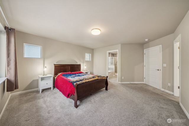 carpeted bedroom featuring connected bathroom