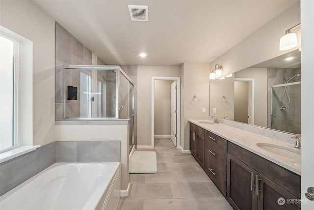 bathroom with tile patterned floors, vanity, and separate shower and tub