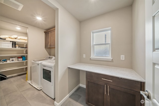 laundry room featuring cabinets, independent washer and dryer, and light tile patterned flooring