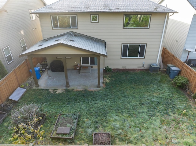 rear view of house featuring a patio area, a yard, and central air condition unit