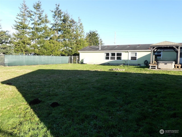 view of yard featuring a gazebo and a hot tub