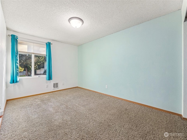 unfurnished room featuring carpet flooring and a textured ceiling