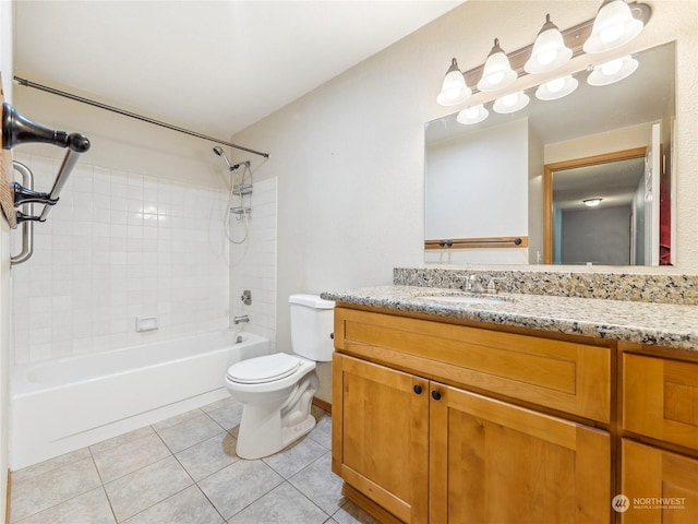 full bathroom featuring tile patterned flooring, vanity, toilet, and tiled shower / bath