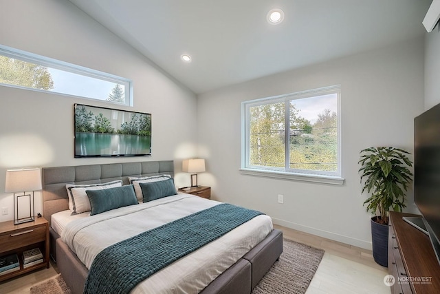 bedroom with light wood-type flooring and lofted ceiling