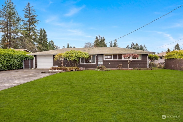 ranch-style home featuring a front lawn and a garage