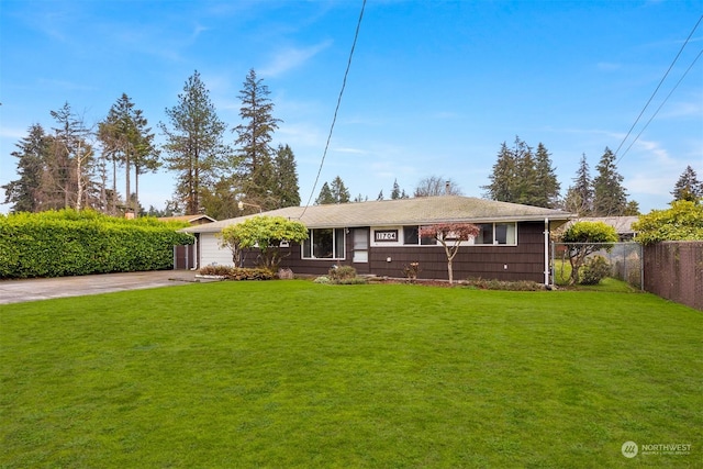 ranch-style house featuring a front lawn and a garage