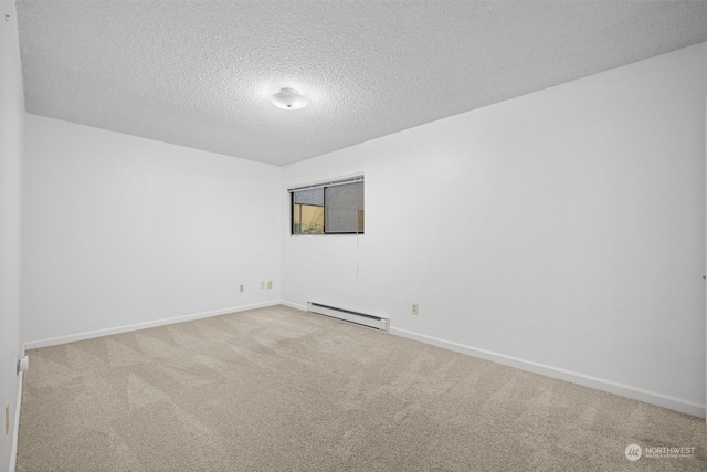 carpeted spare room featuring a textured ceiling and a baseboard radiator