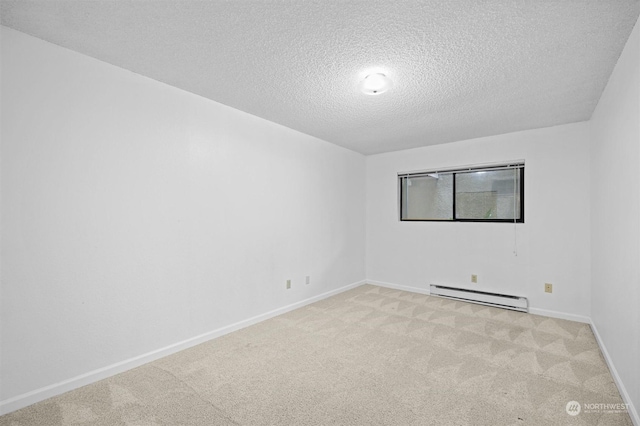 carpeted empty room with a baseboard radiator and a textured ceiling