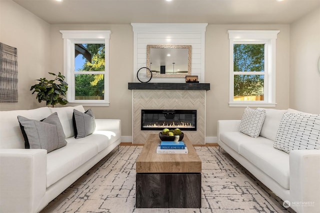 living room featuring a healthy amount of sunlight and a tiled fireplace