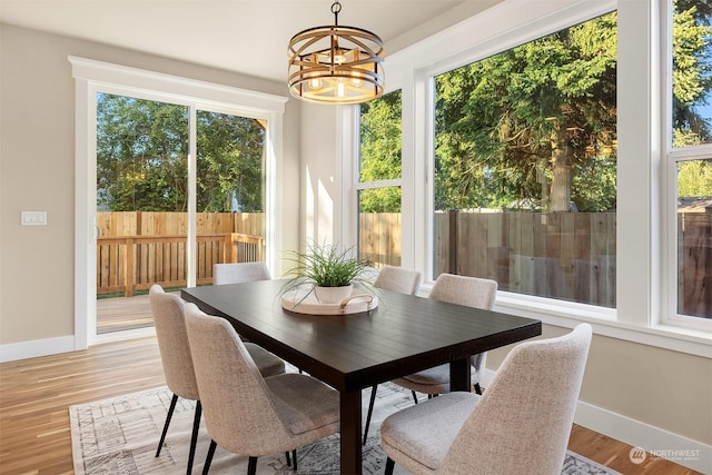 sunroom / solarium featuring a wealth of natural light and an inviting chandelier