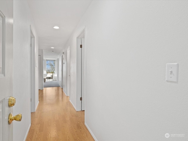 hallway with light hardwood / wood-style floors