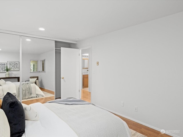 bedroom with a closet and light wood-type flooring