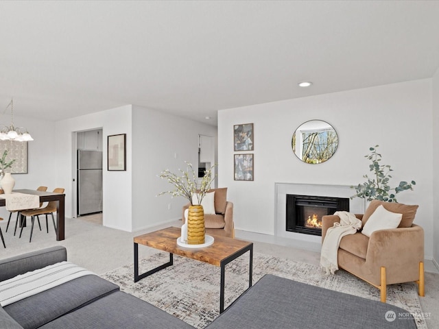 living room with a chandelier and light colored carpet