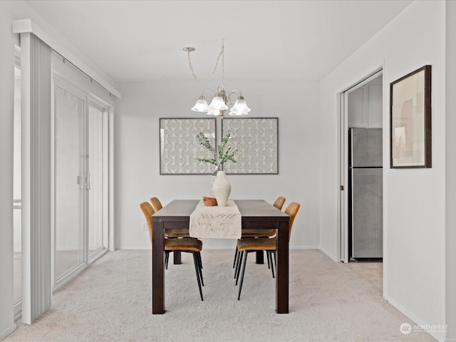 carpeted dining area with a chandelier