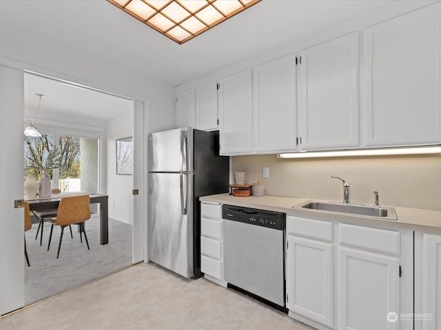 kitchen featuring white cabinets, decorative light fixtures, sink, and stainless steel appliances