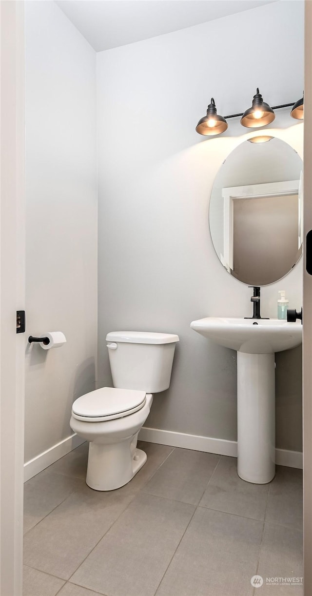 bathroom featuring tile patterned floors and toilet