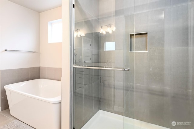 bathroom featuring separate shower and tub and tile patterned flooring