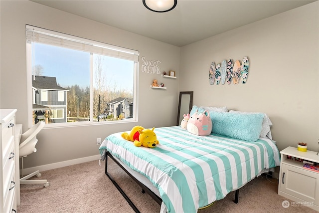 bedroom with multiple windows and light carpet