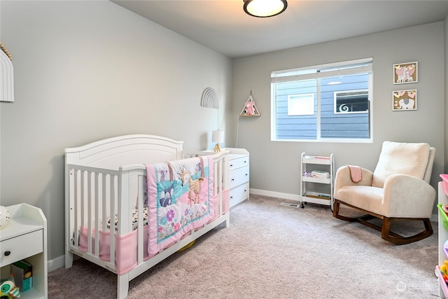 carpeted bedroom with a nursery area