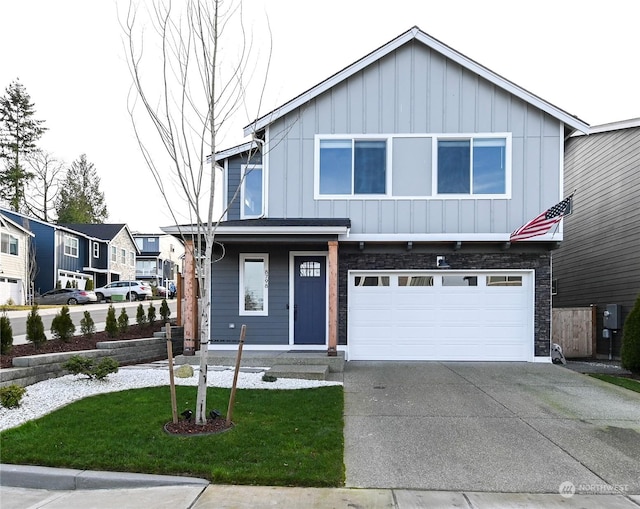 view of front of home featuring a garage and a front lawn