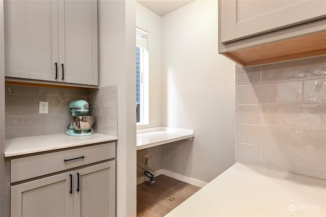 interior space with tasteful backsplash and hardwood / wood-style flooring