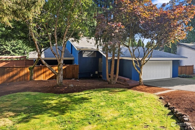 view of front of home with a front lawn and a garage