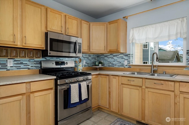 233 Calhoun Loop, Coupeville, WA 98239 - kitchen with appliances with stainless steel finishes, light brown cabinetry, a sink, tasteful backsplash, and light countertops