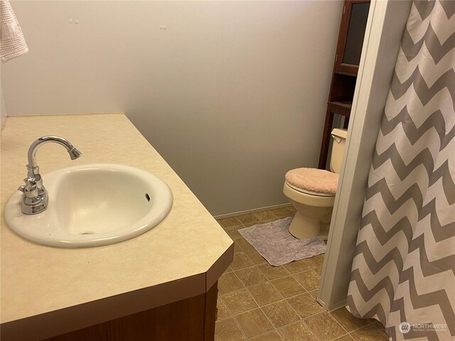 bathroom with tile patterned floors, vanity, and toilet