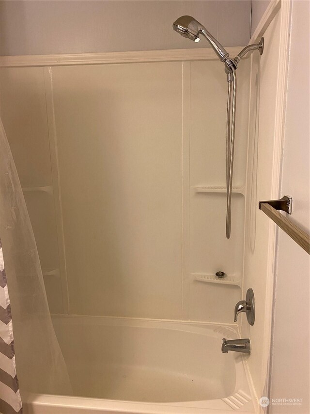 bathroom featuring shower / tub combo with curtain