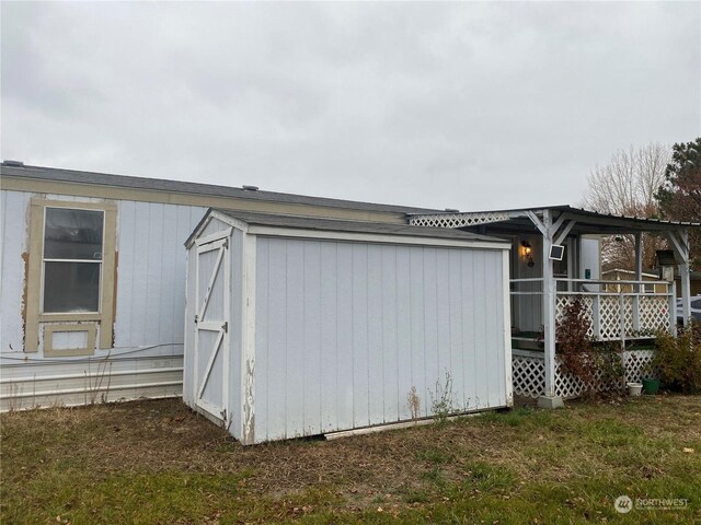 view of property exterior with a storage shed