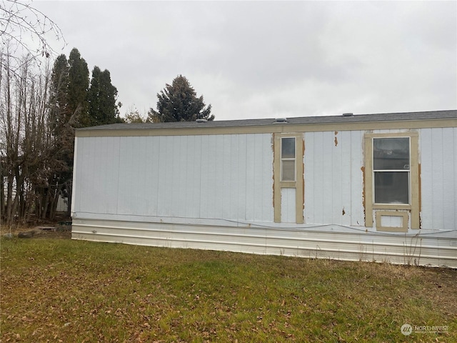 view of side of home featuring a yard