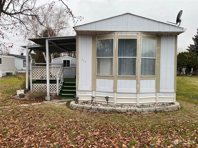 exterior space featuring a storage unit and a lawn