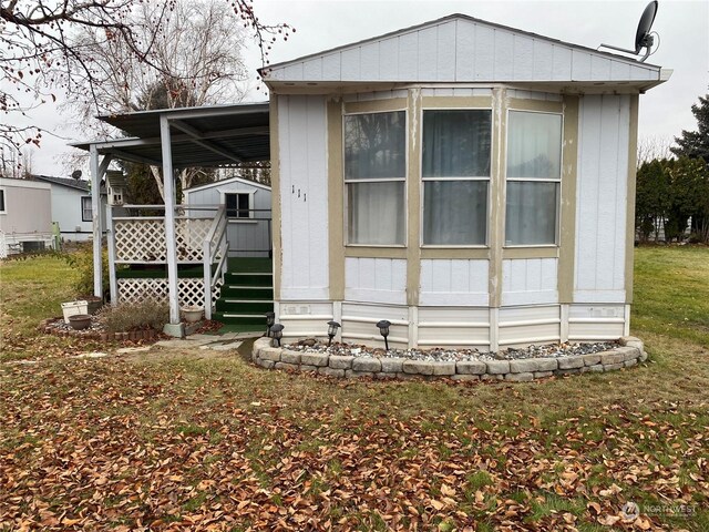 rear view of property featuring a yard