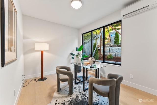 office space with light hardwood / wood-style floors and an AC wall unit