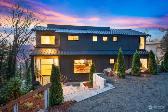 view of back house at dusk