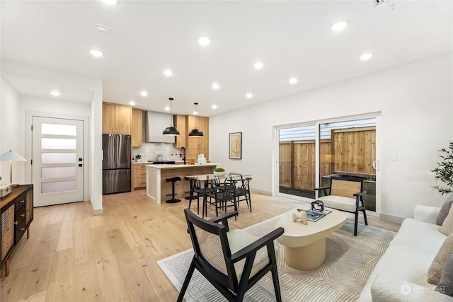 living room with sink and light hardwood / wood-style floors