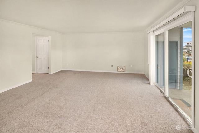 carpeted empty room featuring crown molding