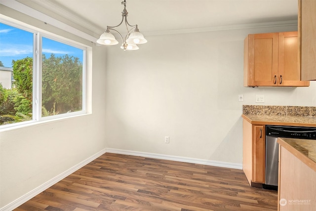 unfurnished dining area featuring dark hardwood / wood-style floors, an inviting chandelier, and crown molding