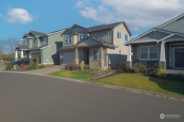 craftsman inspired home featuring a front yard and a garage