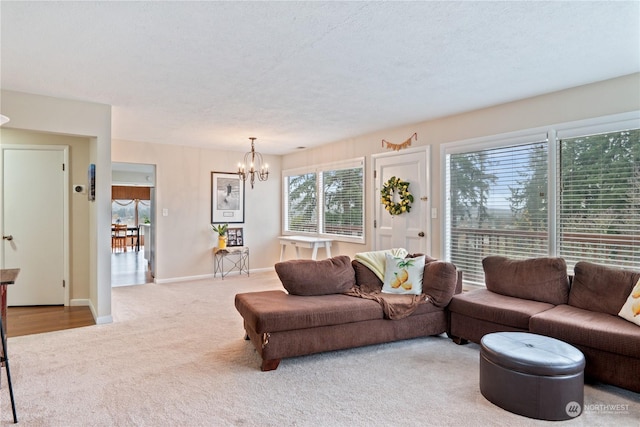 living room with light carpet, a textured ceiling, and a notable chandelier