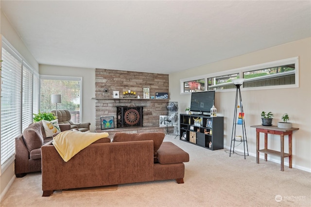 carpeted living room with a stone fireplace