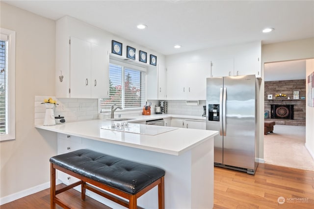 kitchen featuring sink, white cabinetry, and stainless steel appliances