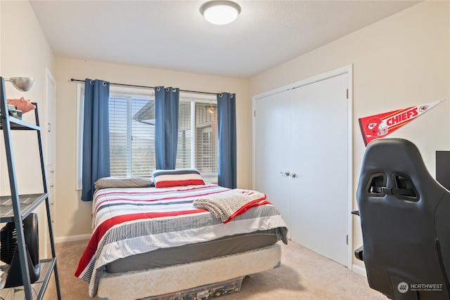 bedroom with light carpet and a closet