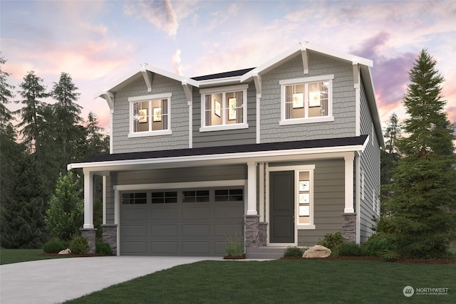 craftsman-style house featuring a garage and a lawn